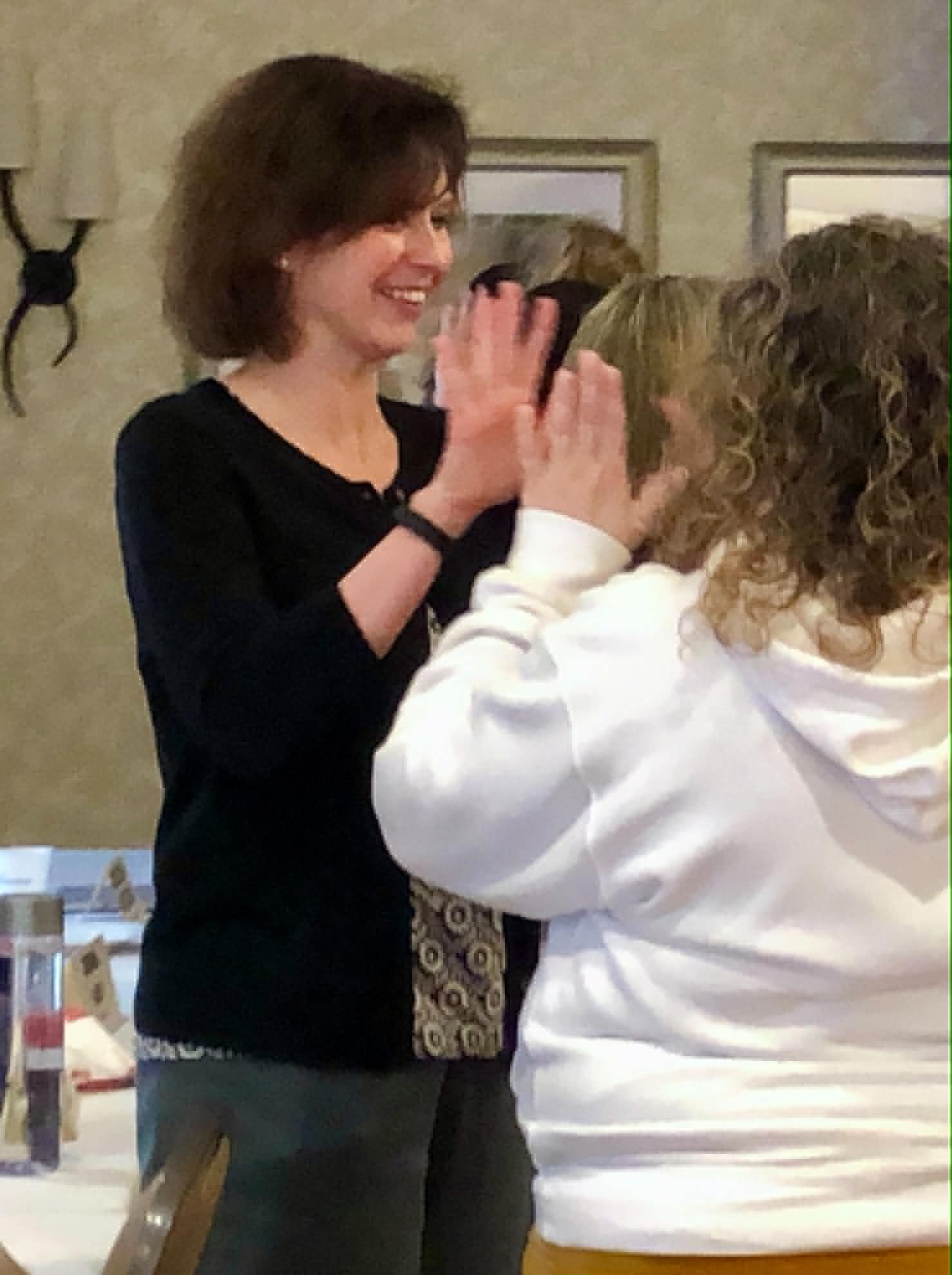 Two Academy participants high-fiving during a session