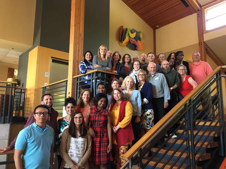 Academy cohort posed together on a stairway