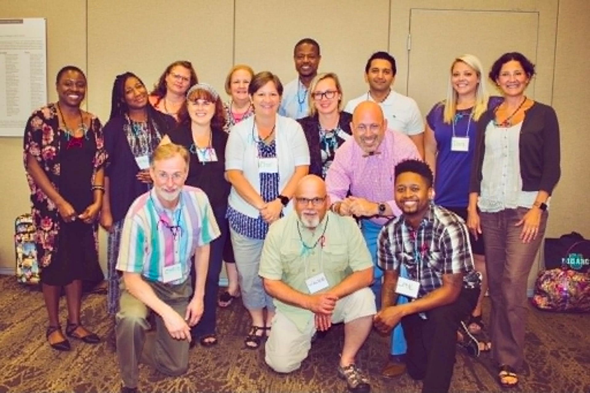 A large Academy cohort posed together in a conference room