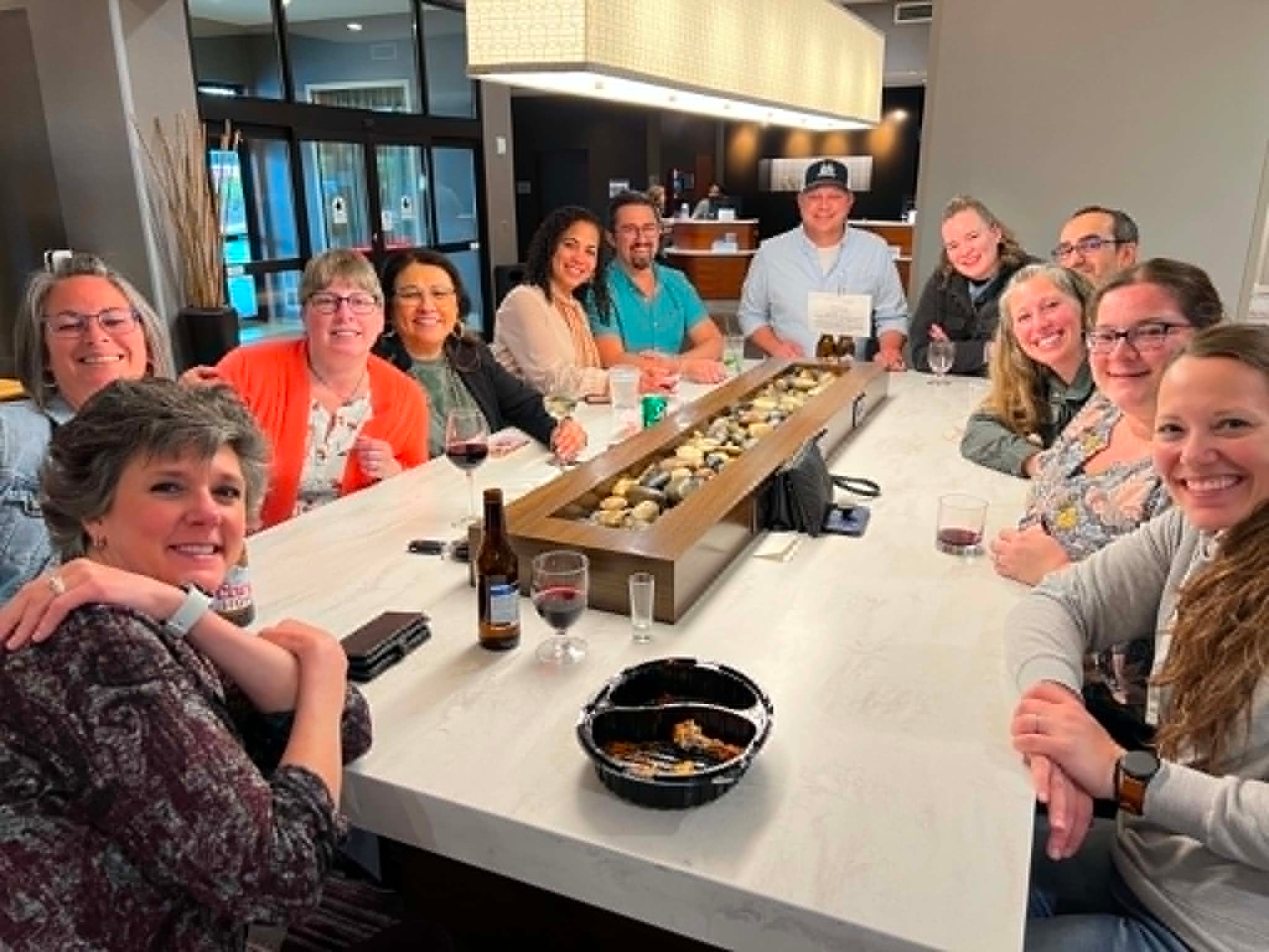 Academy cohort gathered around a table sharing dinner together