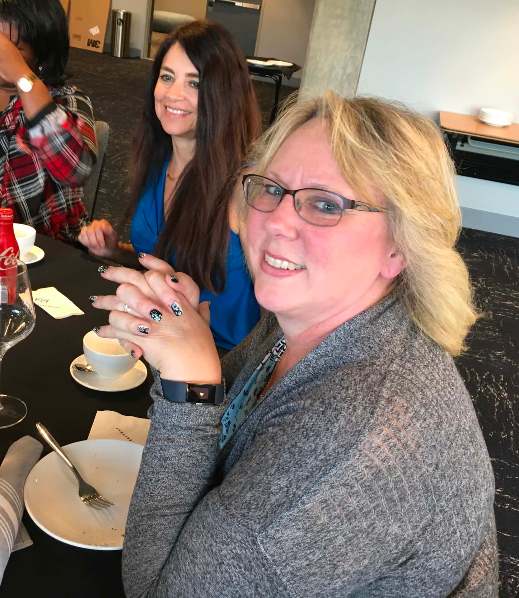 Two Academy participants smiling at the table during a cohort meal