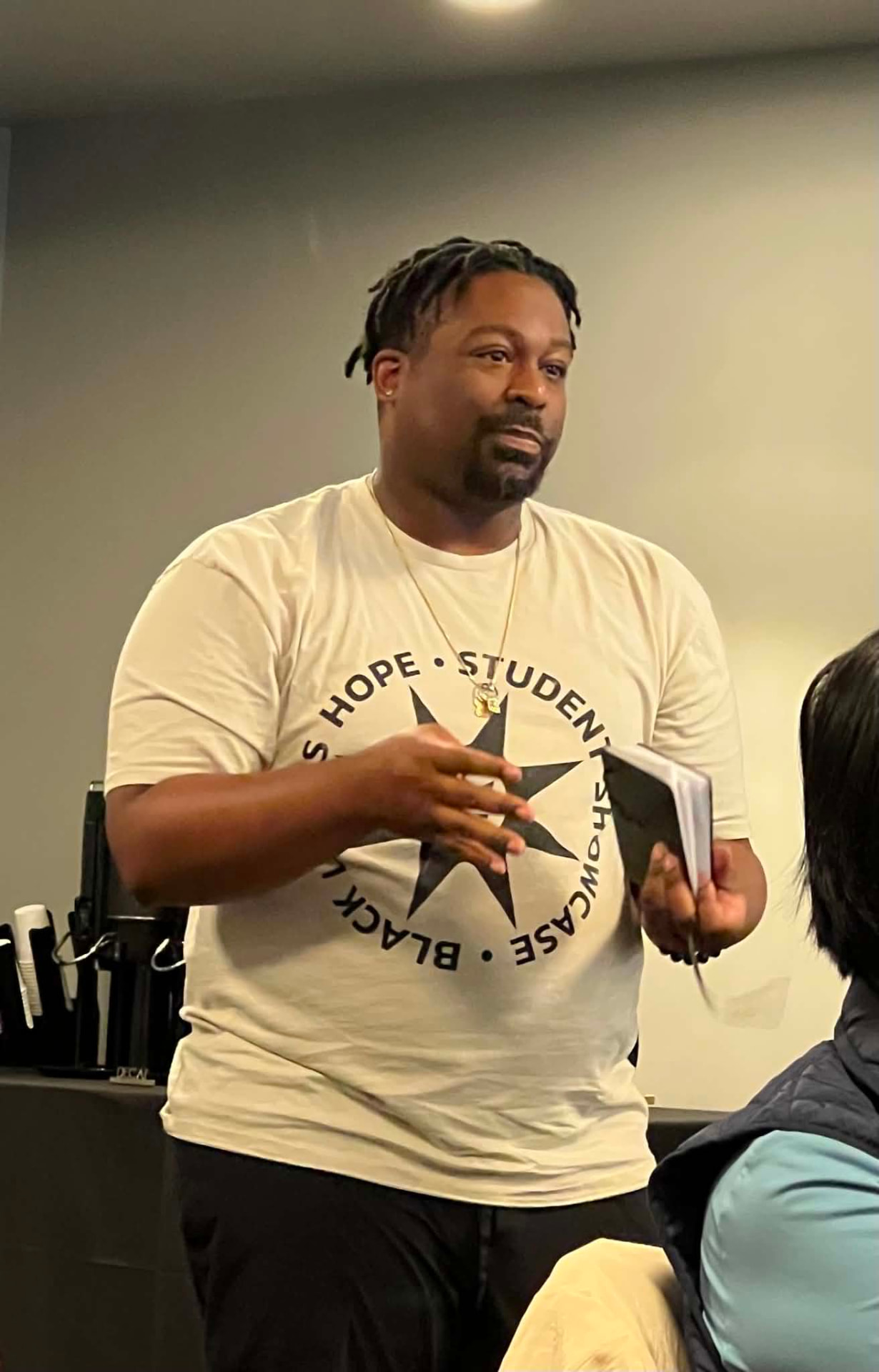 An Academy participant standing and speaking to the group during a session