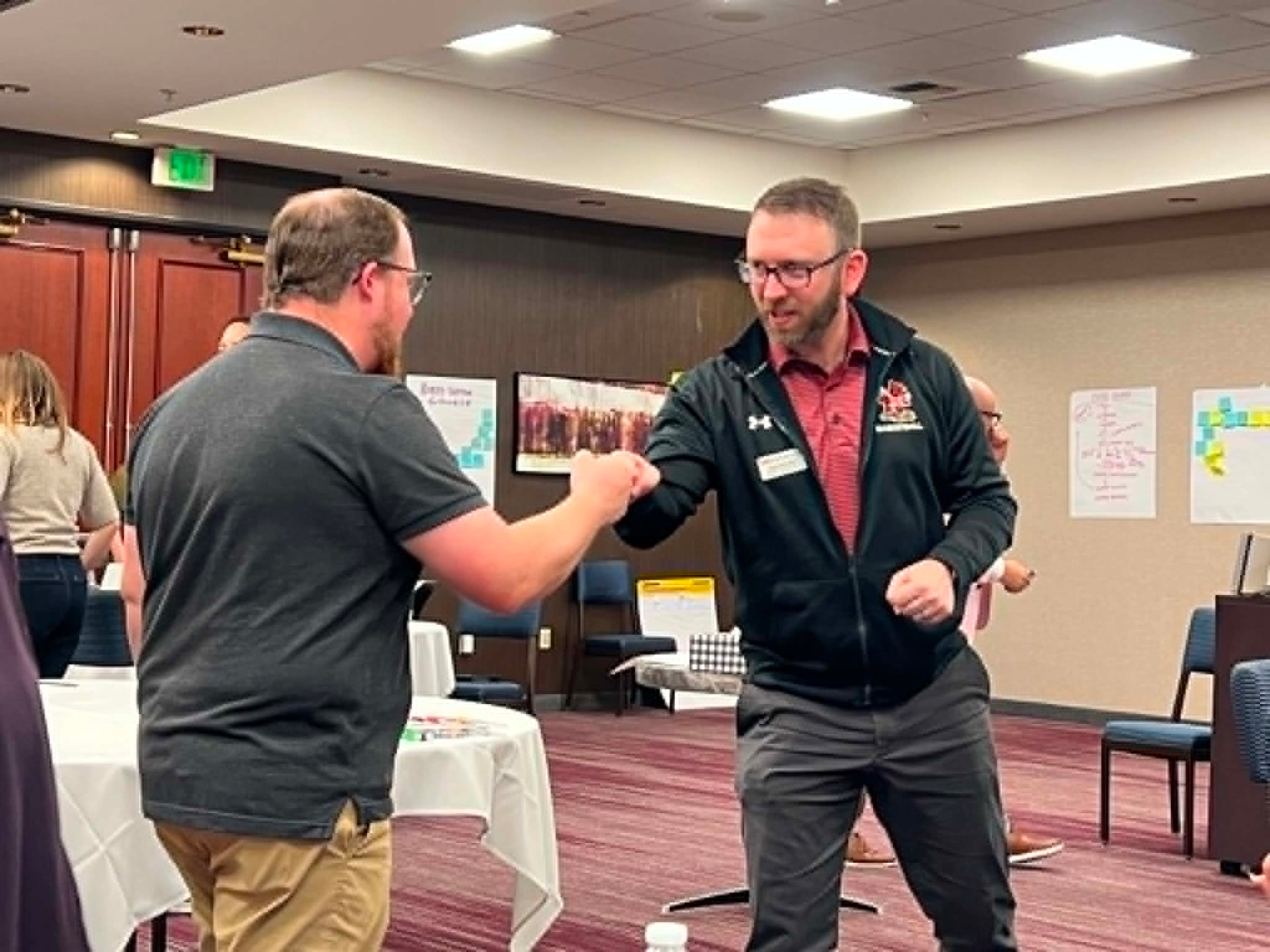 Two Academy participants sharing a fist bump