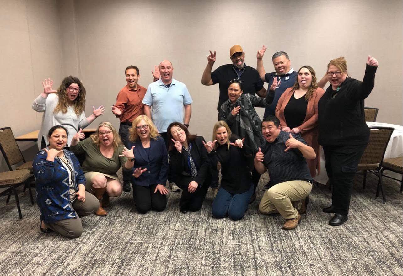 Academy cohort cheering together during an energizer activity