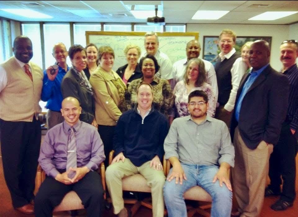 An Academy cohort seated together in a conference room during a session