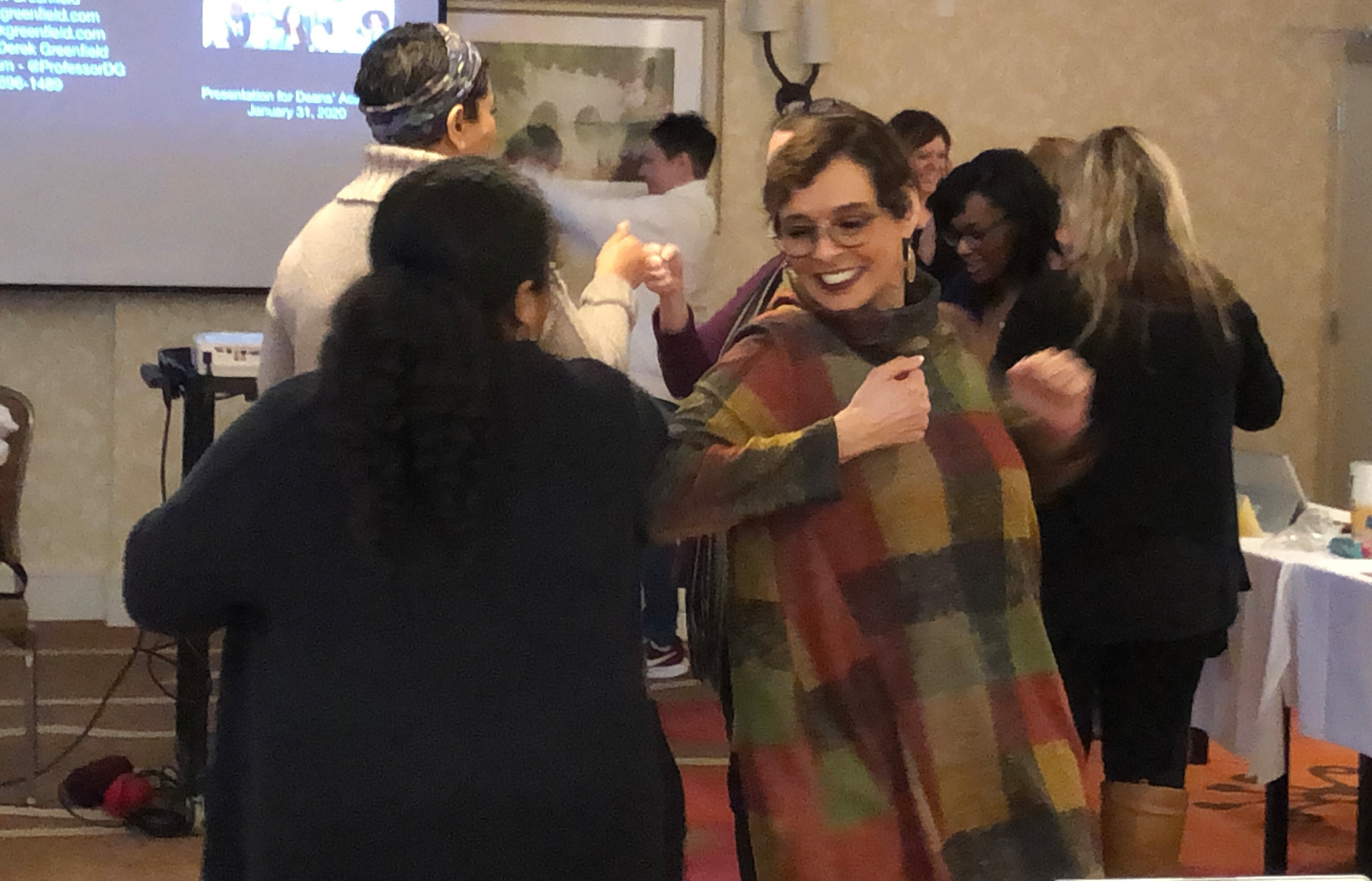 Academy participants laughing during an interactive keynote presentation